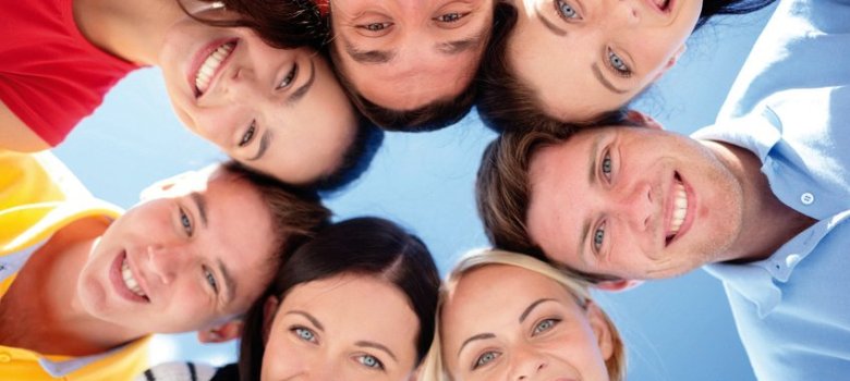 smiling friends in circle on summer beach smiling friends in circle on summer beach